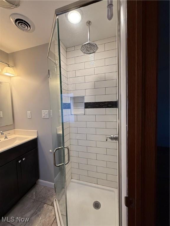 120 Woodcrest Dr, Marietta, OH 45750 - bathroom featuring a shower stall, vanity, baseboards, and marble look tiles