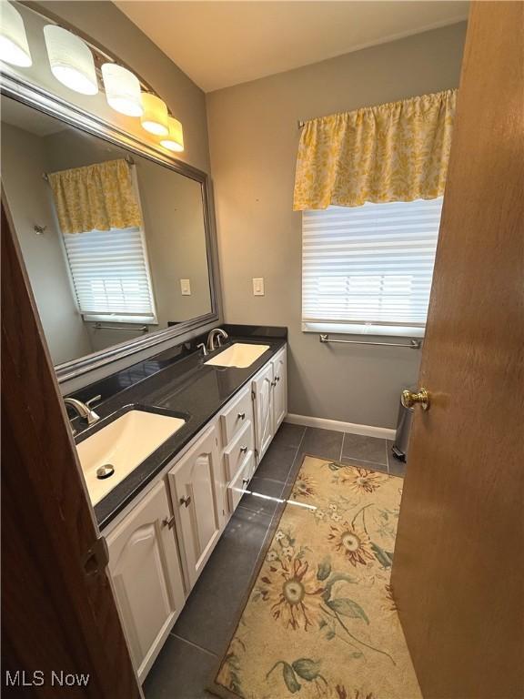 120 Woodcrest Dr, Marietta, OH 45750 - bathroom with tile patterned floors, double vanity, and baseboards