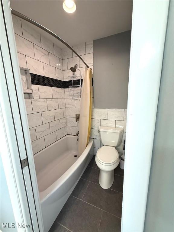 120 Woodcrest Dr, Marietta, OH 45750 - bathroom with tile patterned flooring, tile walls, toilet, shower / bath combo with shower curtain, and wainscoting