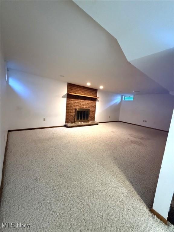 120 Woodcrest Dr, Marietta, OH 45750 - unfurnished living room featuring carpet flooring, a fireplace, lofted ceiling, and baseboards