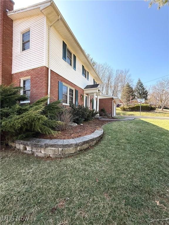 120 Woodcrest Dr, Marietta, OH 45750 - view of side of home featuring brick siding and a lawn