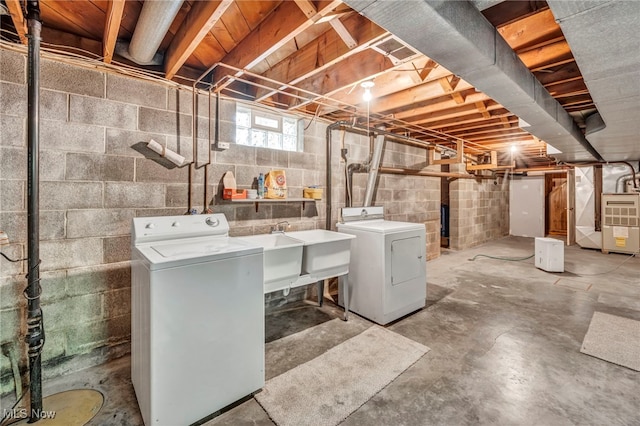 laundry room with independent washer and dryer, heating unit, and sink