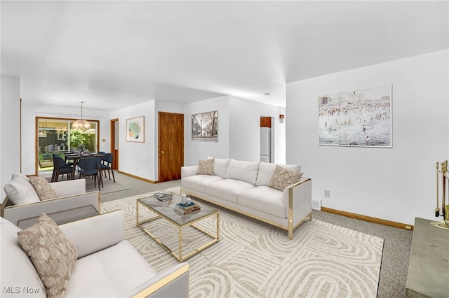 carpeted living room with a chandelier