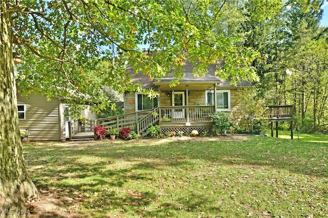 obstructed view of property featuring a deck and a front lawn