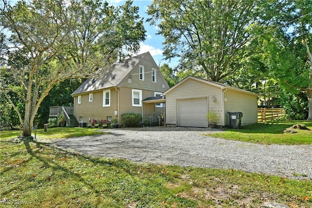 view of front of property featuring a garage, a front lawn, and central AC