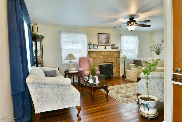 sitting room featuring ceiling fan, hardwood / wood-style flooring, a fireplace, and plenty of natural light