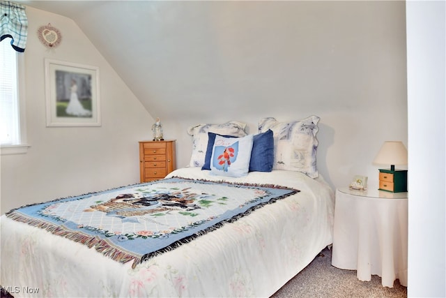 bedroom with lofted ceiling and carpet