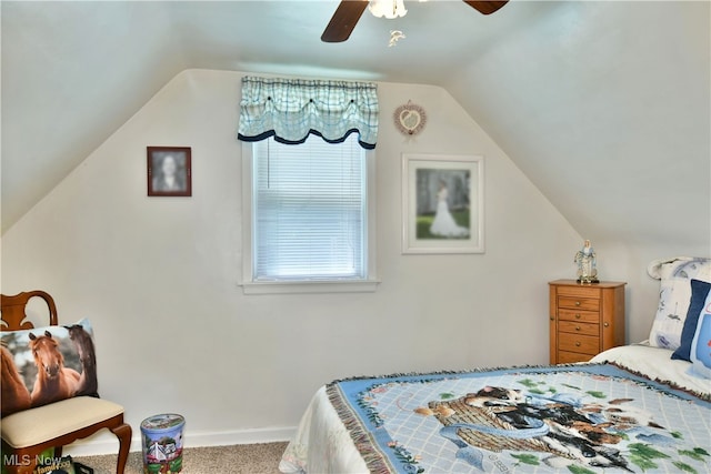 bedroom with ceiling fan, carpet flooring, and vaulted ceiling