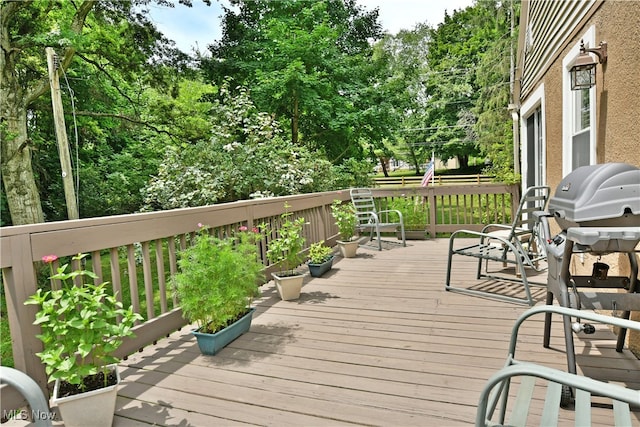 wooden deck featuring area for grilling