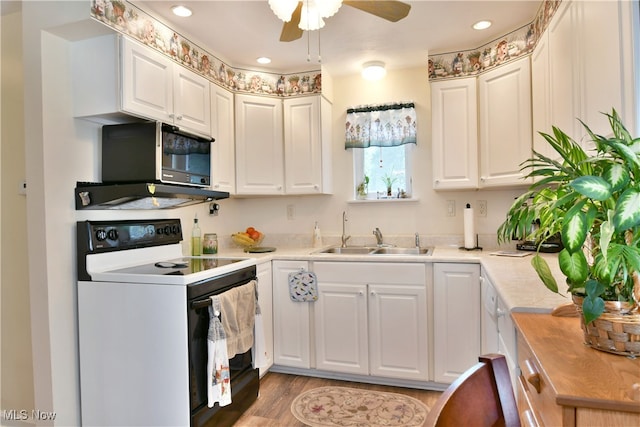 kitchen featuring light hardwood / wood-style floors, white electric range, ceiling fan, sink, and white cabinetry