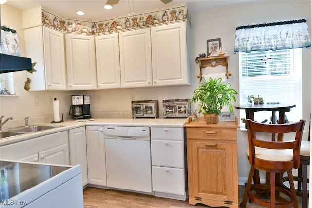 kitchen featuring white cabinets, white dishwasher, and light wood-type flooring