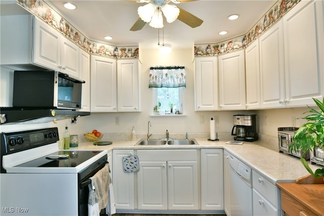 kitchen featuring ceiling fan, white cabinets, sink, and white appliances