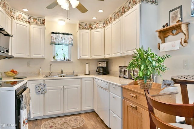 kitchen featuring ceiling fan, white cabinets, white appliances, sink, and light hardwood / wood-style flooring