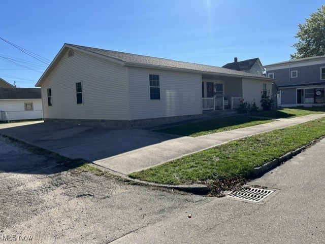 view of side of home featuring a lawn