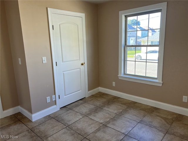 spare room with light tile patterned floors