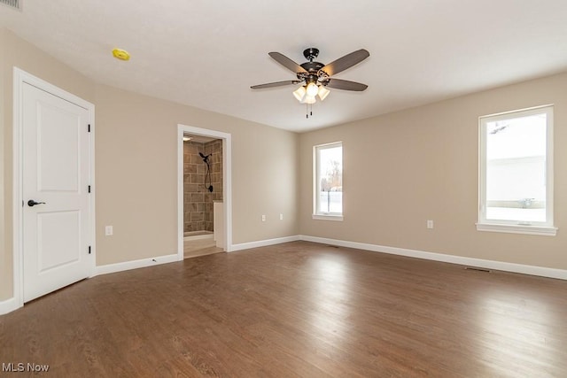 unfurnished room featuring ceiling fan and dark hardwood / wood-style flooring