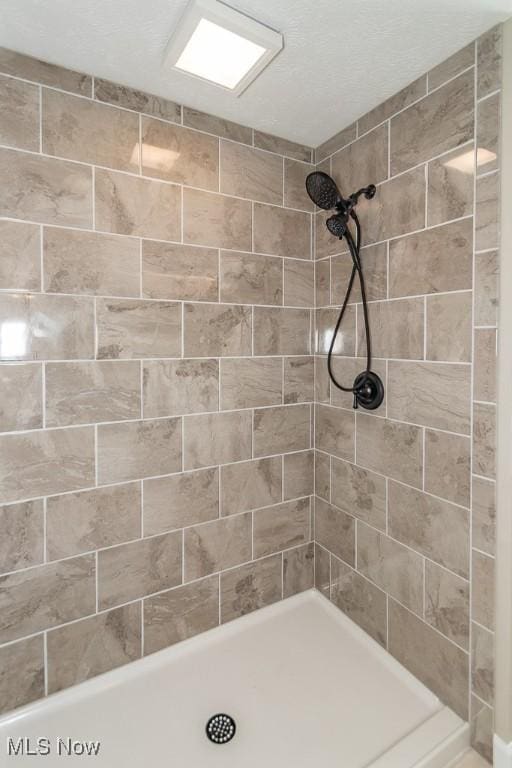 bathroom with a tile shower