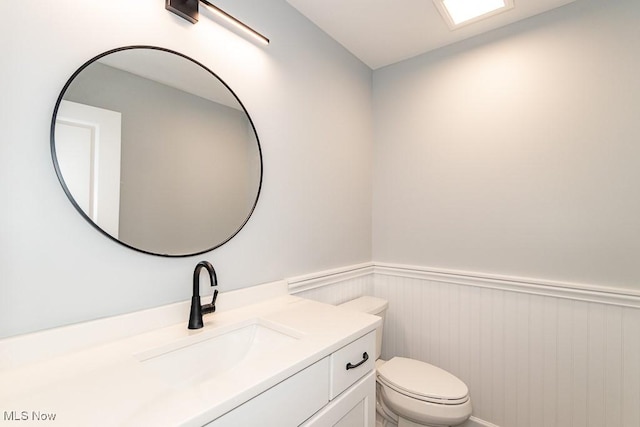 bathroom featuring toilet and vanity