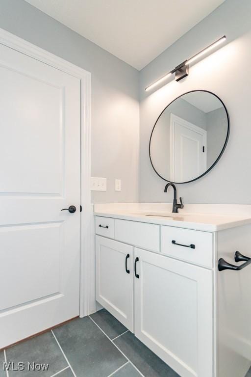 bathroom with tile patterned floors and vanity