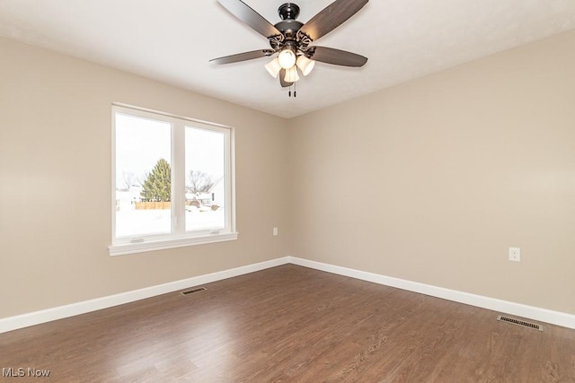 unfurnished room featuring ceiling fan and dark hardwood / wood-style floors