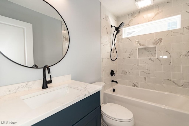 full bathroom with toilet, vanity, and tiled shower / bath