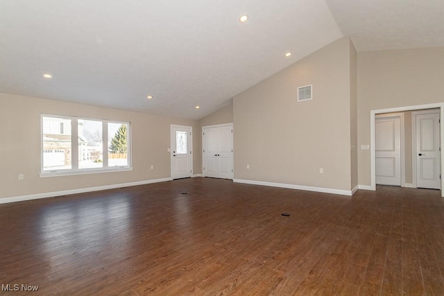 unfurnished living room featuring high vaulted ceiling and dark hardwood / wood-style floors