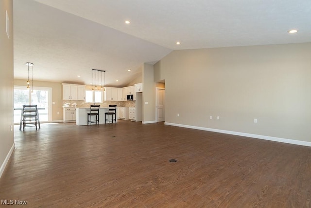 unfurnished living room featuring dark hardwood / wood-style floors and high vaulted ceiling