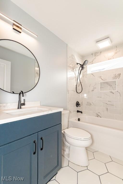 full bathroom featuring toilet, tiled shower / bath, and vanity