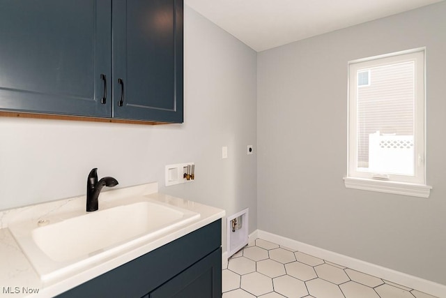 laundry area with cabinets, sink, hookup for a washing machine, and hookup for an electric dryer