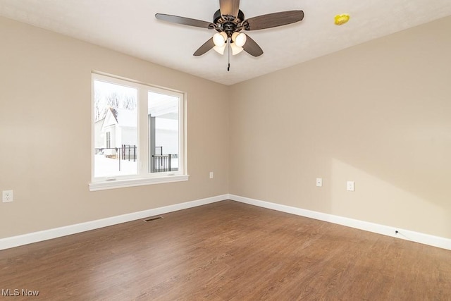 empty room featuring ceiling fan and hardwood / wood-style floors