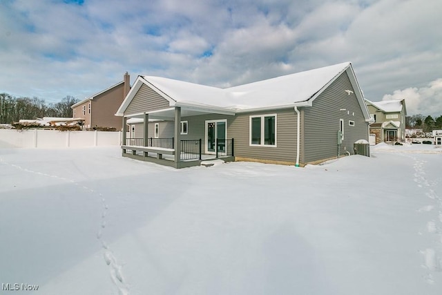 snow covered house with covered porch