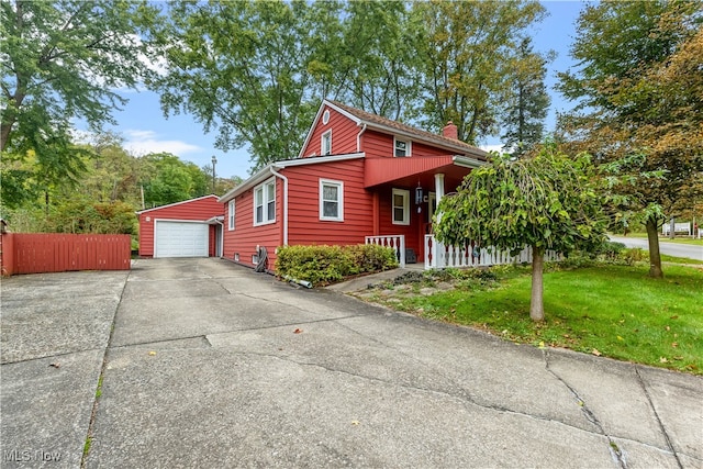 view of front of home with a front yard, a garage, and a porch