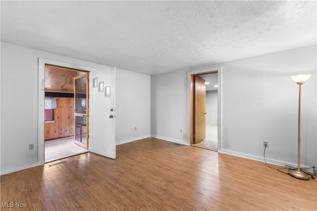 empty room featuring hardwood / wood-style floors and a textured ceiling