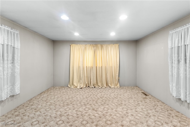 carpeted empty room featuring plenty of natural light