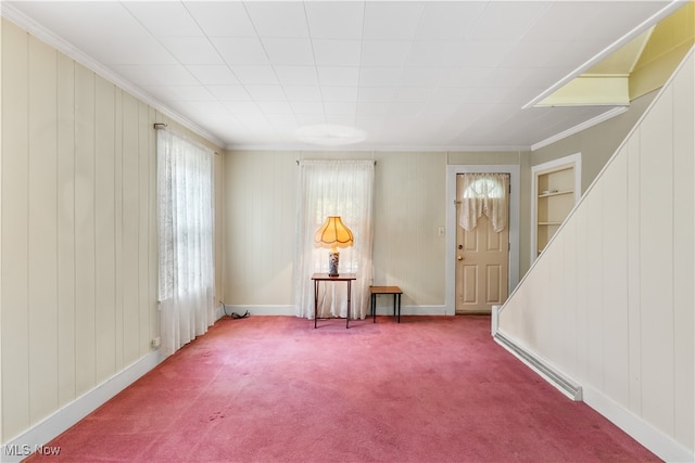 spare room with ornamental molding, carpet, and built in features