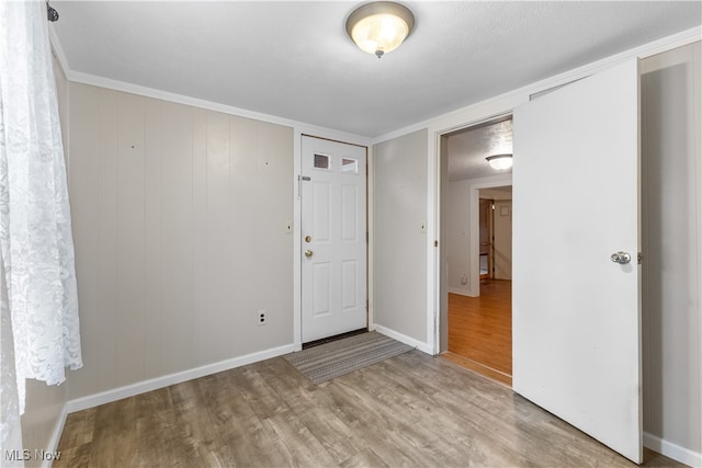 spare room featuring a textured ceiling and light wood-type flooring