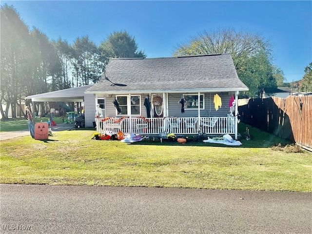 view of front of house with a porch, a front lawn, and a carport