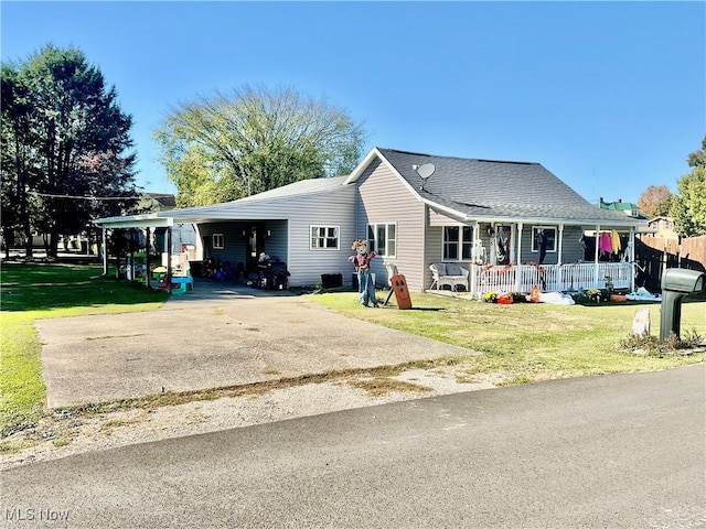 view of front of home with a porch, a carport, and a front lawn