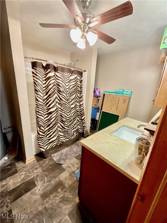 bathroom featuring ceiling fan, vanity, and shower / tub combo