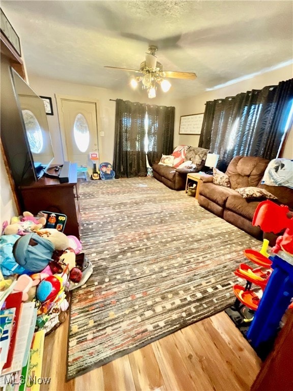 rec room with ceiling fan and hardwood / wood-style floors