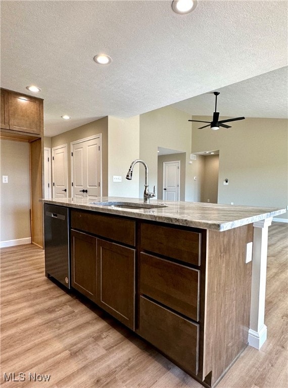 kitchen featuring dishwasher, a center island with sink, light hardwood / wood-style flooring, and sink