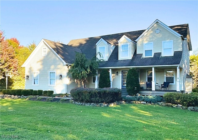 cape cod house featuring a front lawn and covered porch