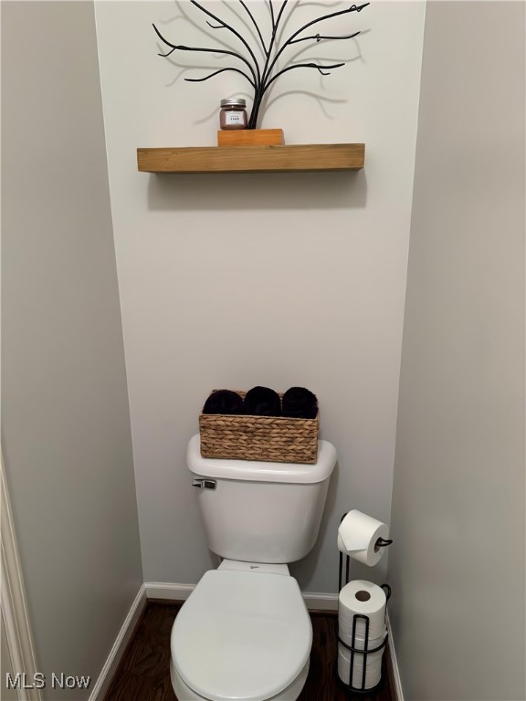 bathroom featuring hardwood / wood-style floors and toilet