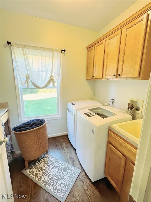 laundry area featuring separate washer and dryer, cabinets, sink, and dark hardwood / wood-style flooring