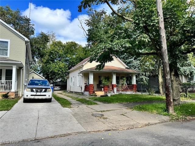 view of front of property featuring covered porch and concrete driveway