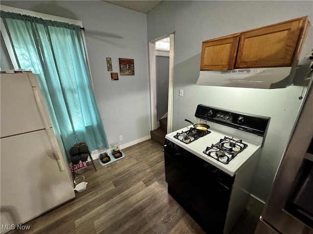 kitchen with white appliances and dark hardwood / wood-style floors