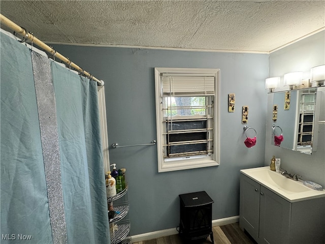 bathroom with a textured ceiling, curtained shower, vanity, and hardwood / wood-style flooring