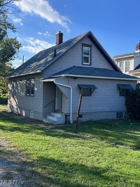 rear view of property with a yard