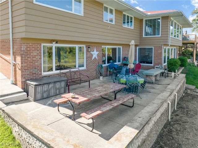 back of house with a jacuzzi and a patio area