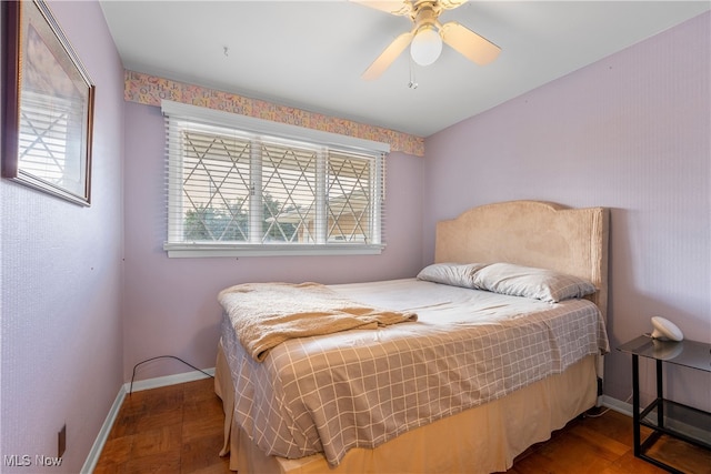 bedroom featuring ceiling fan and parquet floors